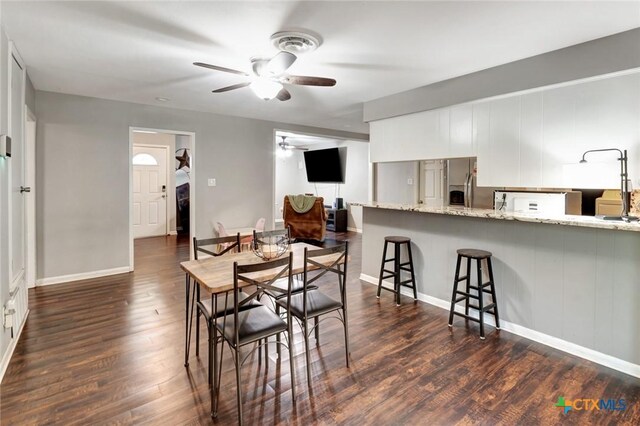 1808 Mission Dr, Victoria, TX 77901 - dining area featuring ceiling fan, dark wood-style flooring, and baseboards