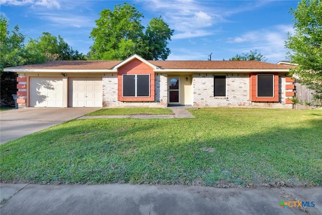 1808 Mission Dr, Victoria, TX 77901 - ranch-style house featuring a garage, concrete driveway, a front yard, and brick siding