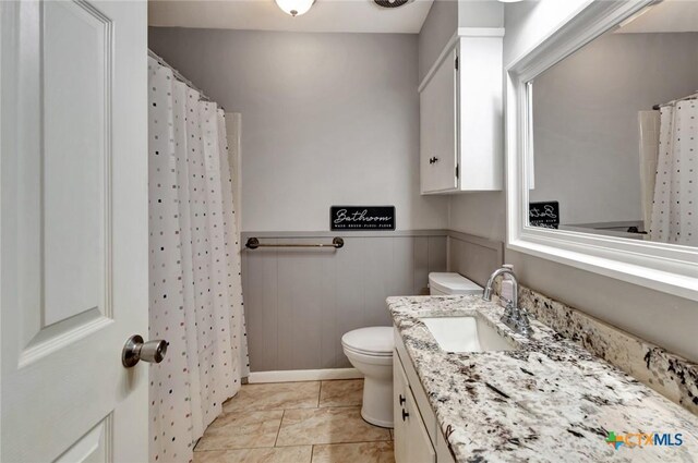 1808 Mission Dr, Victoria, TX 77901 - bathroom featuring vanity, toilet, wainscoting, and a shower with shower curtain