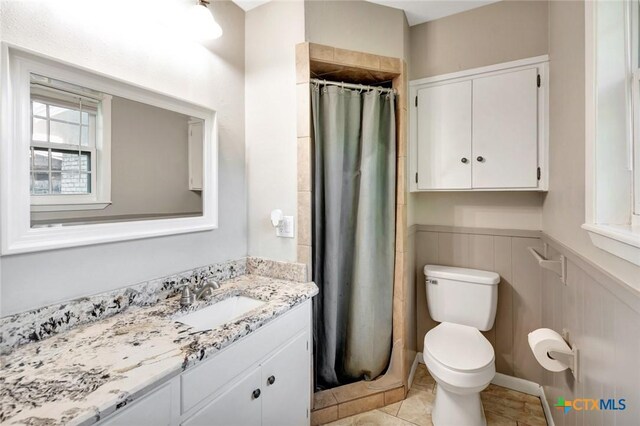 1808 Mission Dr, Victoria, TX 77901 - bathroom featuring vanity, toilet, a shower with shower curtain, and wainscoting