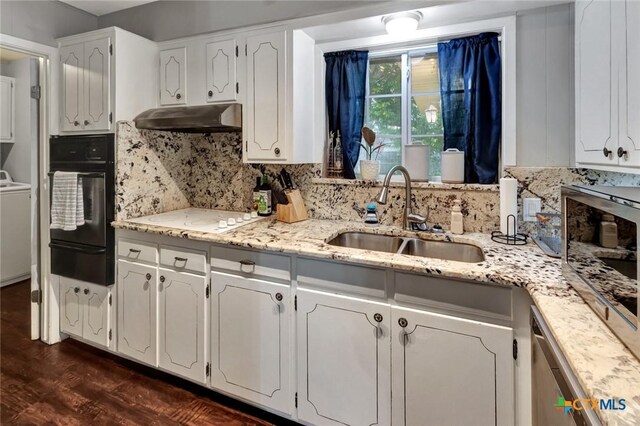 1808 Mission Dr, Victoria, TX 77901 - kitchen featuring oven, a warming drawer, under cabinet range hood, a sink, and white cooktop