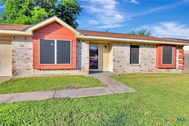 1808 Mission Dr, Victoria, TX 77901 - ranch-style house featuring brick siding, a front lawn, and an attached garage