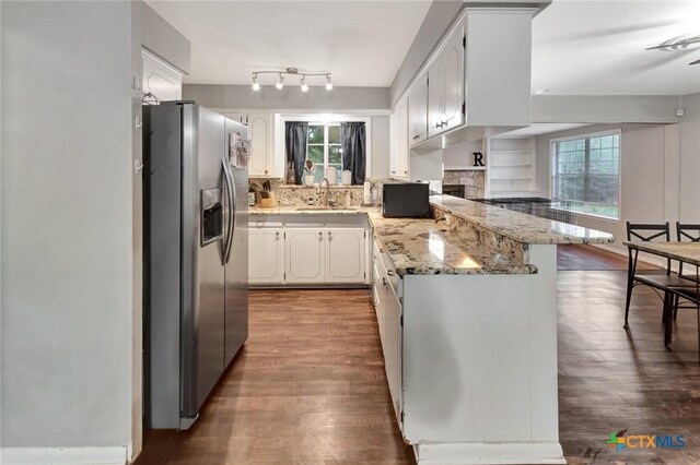 1808 Mission Dr, Victoria, TX 77901 - kitchen featuring stainless steel fridge with ice dispenser, a peninsula, dark wood-style flooring, a sink, and white cabinets