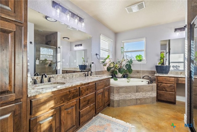 bathroom with a textured ceiling, vanity, and separate shower and tub