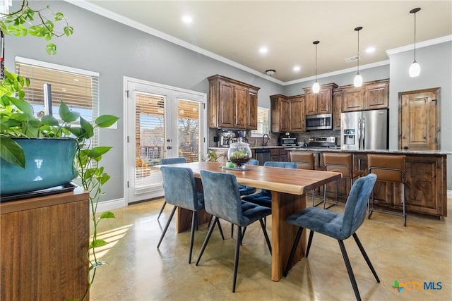 kitchen with sink, hanging light fixtures, crown molding, decorative backsplash, and appliances with stainless steel finishes