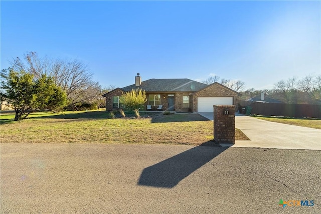 ranch-style home with a garage and a front lawn