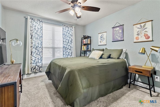 bedroom with ceiling fan and light carpet