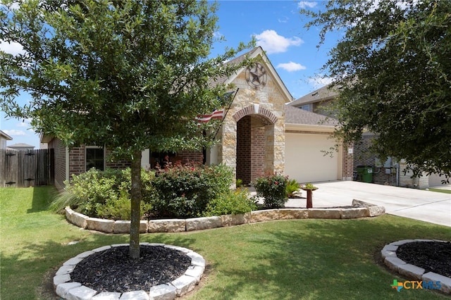 521 Kirkhill St, Hutto, TX 78634 - view of front of house with stone siding, an attached garage, driveway, and brick siding