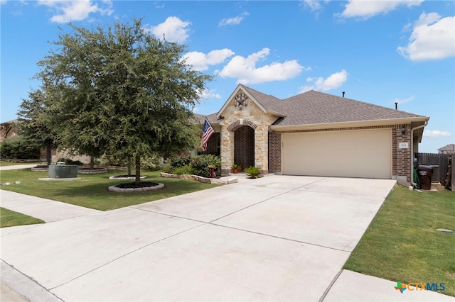 521 Kirkhill St, Hutto, TX 78634 - view of front of property featuring a garage, driveway, brick siding, roof with shingles, and stone siding