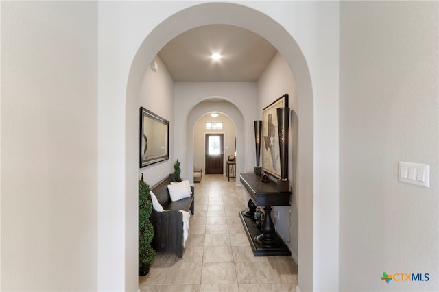 521 Kirkhill St, Hutto, TX 78634 - hallway with arched walkways and light tile patterned floors