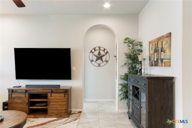 521 Kirkhill St, Hutto, TX 78634 - living room featuring light marble finish flooring, arched walkways, baseboards, recessed lighting, and a ceiling fan