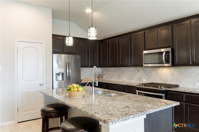 521 Kirkhill St, Hutto, TX 78634 - kitchen featuring appliances with stainless steel finishes, a sink, dark brown cabinets, decorative backsplash, and lofted ceiling