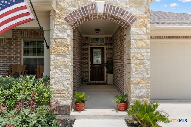 521 Kirkhill St, Hutto, TX 78634 - entrance to property featuring stone siding, a shingled roof, and brick siding