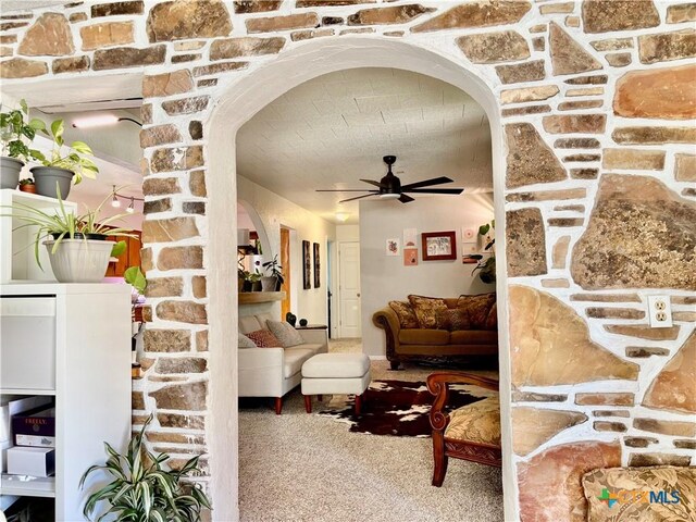 1003 Standifer St, Lampasas, TX 76550 - living area featuring arched walkways, ceiling fan, and carpet flooring