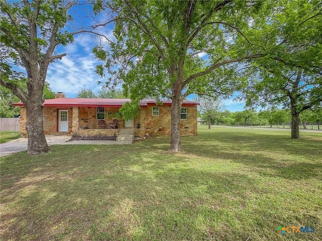 1003 Standifer St, Lampasas, TX 76550 - ranch-style house featuring stone siding, a porch, a chimney, and a front yard