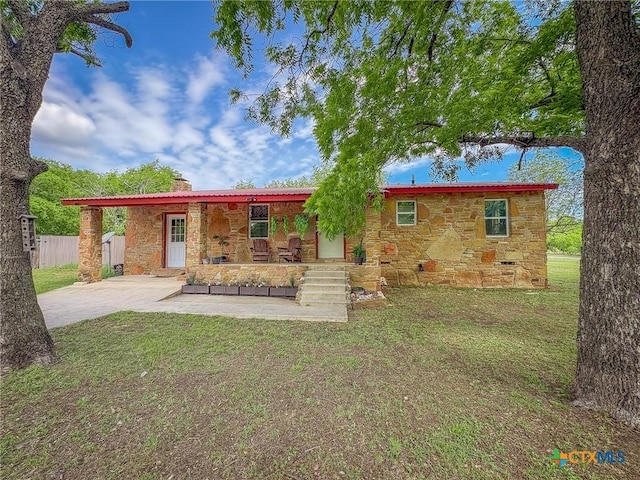 1003 Standifer St, Lampasas, TX 76550 - rear view of property featuring stone siding, a chimney, and concrete driveway