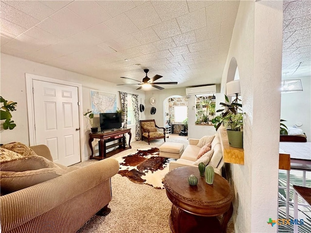 1003 Standifer St, Lampasas, TX 76550 - living area featuring a wall mounted air conditioner, arched walkways, ceiling fan, and carpet flooring