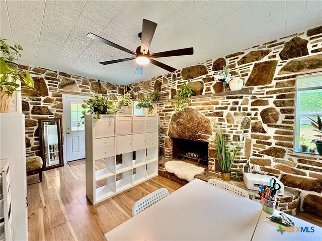 1003 Standifer St, Lampasas, TX 76550 - unfurnished room with a fireplace, light wood-style flooring, and a ceiling fan