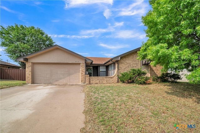 ranch-style home featuring concrete driveway, brick siding, an attached garage, and fence