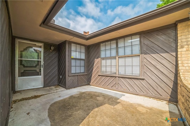 entrance to property with a patio