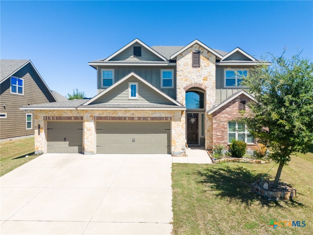 view of front of property with a garage and a front yard