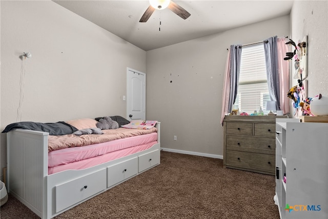 bedroom with dark colored carpet and ceiling fan