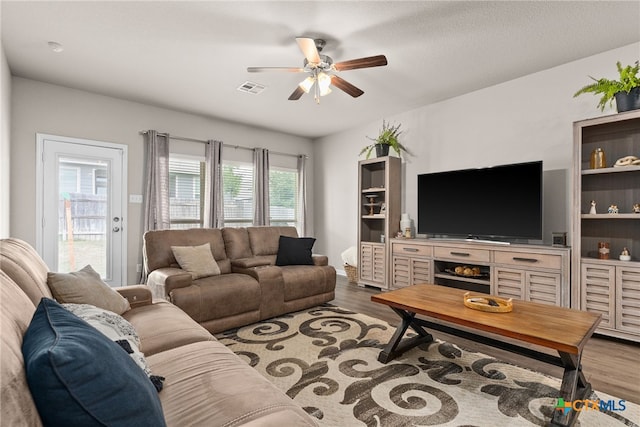 living room with hardwood / wood-style flooring and ceiling fan