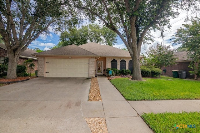 216 Ridge Dr, Victoria, TX 77904 - view of front facade featuring brick siding, concrete driveway, an attached garage, and a front yard