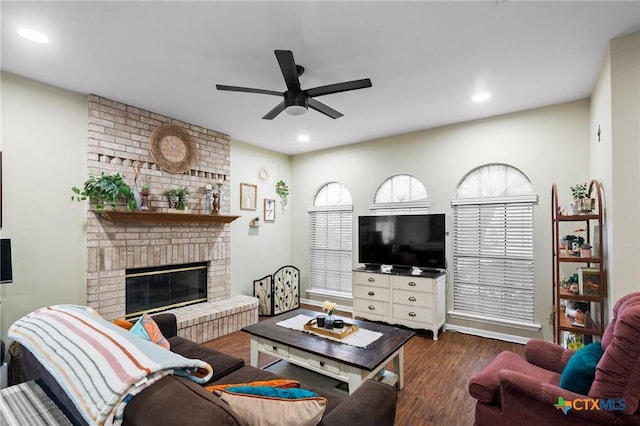 216 Ridge Dr, Victoria, TX 77904 - living room with ceiling fan, dark wood-type flooring, a brick fireplace, and recessed lighting