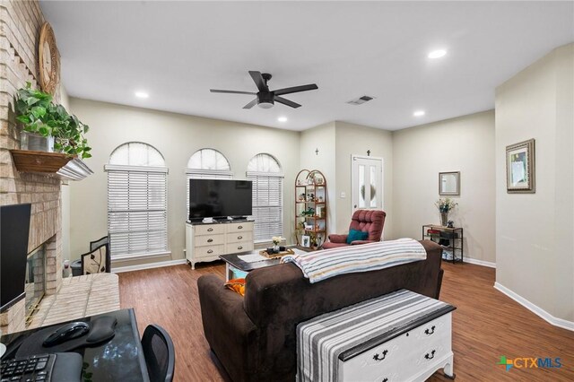 216 Ridge Dr, Victoria, TX 77904 - living area featuring a ceiling fan, a fireplace, wood finished floors, and recessed lighting