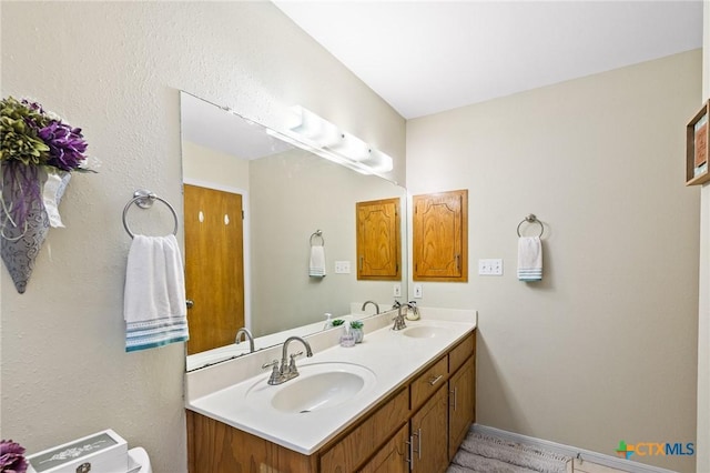 216 Ridge Dr, Victoria, TX 77904 - bathroom featuring double vanity and baseboards