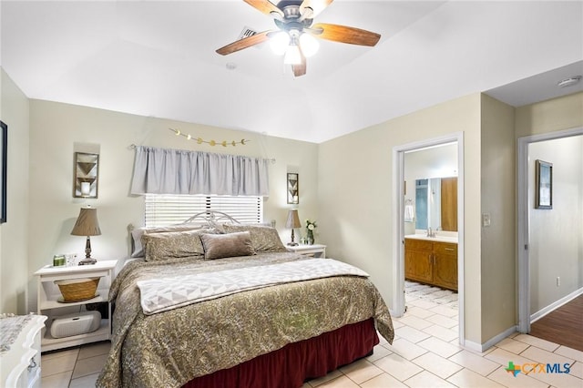 216 Ridge Dr, Victoria, TX 77904 - bedroom with light tile patterned floors, ensuite bathroom, and ceiling fan