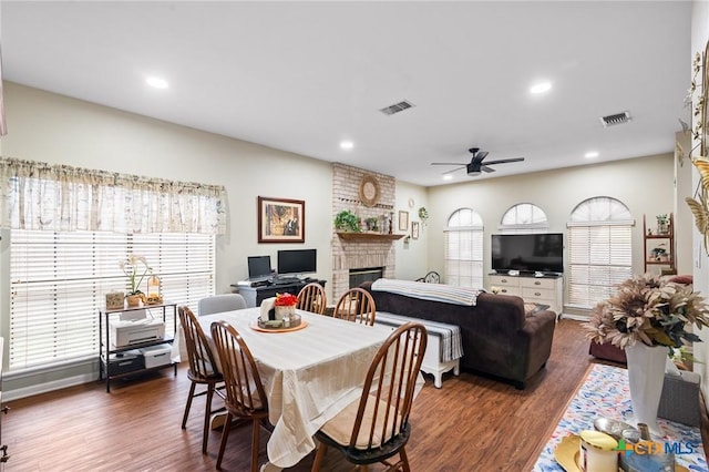 216 Ridge Dr, Victoria, TX 77904 - dining area featuring a ceiling fan, a brick fireplace, wood finished floors, and recessed lighting