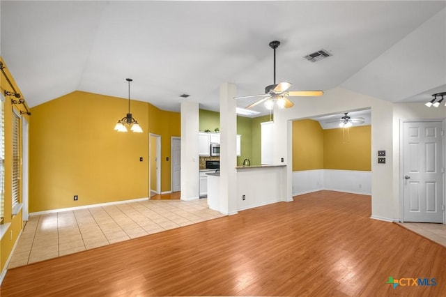 908 Pennsylvania Ave, Victoria, TX 77904 - unfurnished living room featuring lofted ceiling, light wood-style flooring, and ceiling fan