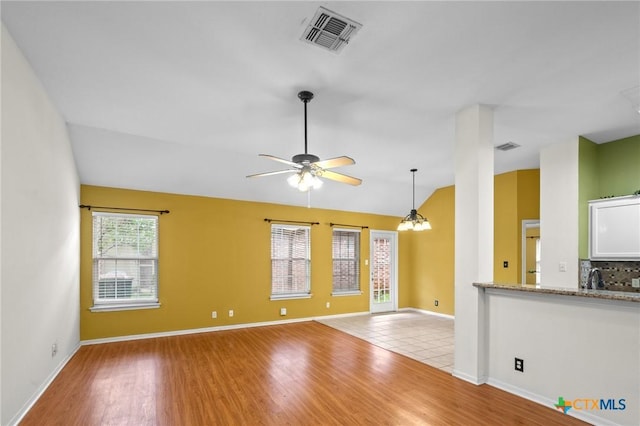 908 Pennsylvania Ave, Victoria, TX 77904 - unfurnished living room with wood finished floors, lofted ceiling, and ceiling fan