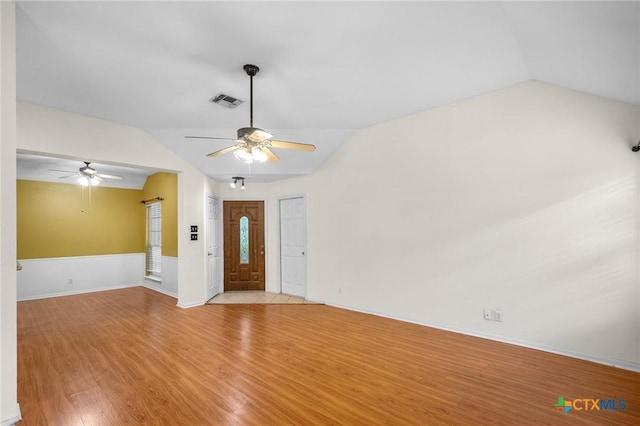908 Pennsylvania Ave, Victoria, TX 77904 - unfurnished living room featuring a ceiling fan, vaulted ceiling, and light wood-style flooring