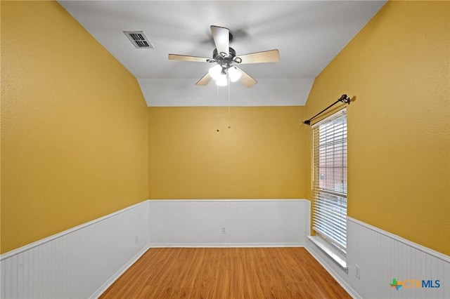 908 Pennsylvania Ave, Victoria, TX 77904 - empty room featuring a wainscoted wall, wood finished floors, ceiling fan, and lofted ceiling
