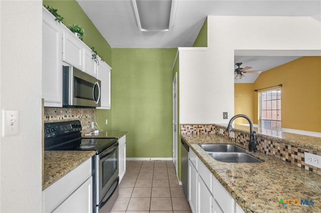 908 Pennsylvania Ave, Victoria, TX 77904 - kitchen with appliances with stainless steel finishes, decorative backsplash, white cabinets, light stone countertops, and a ceiling fan