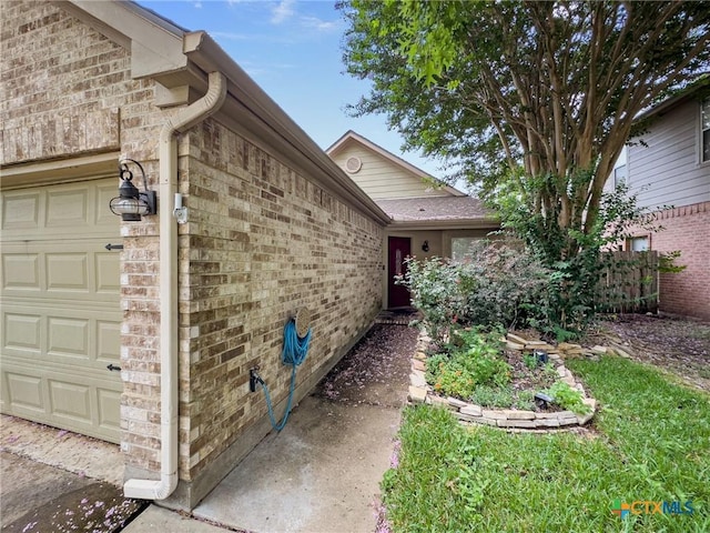 908 Pennsylvania Ave, Victoria, TX 77904 - view of exterior entry featuring a garage and brick siding