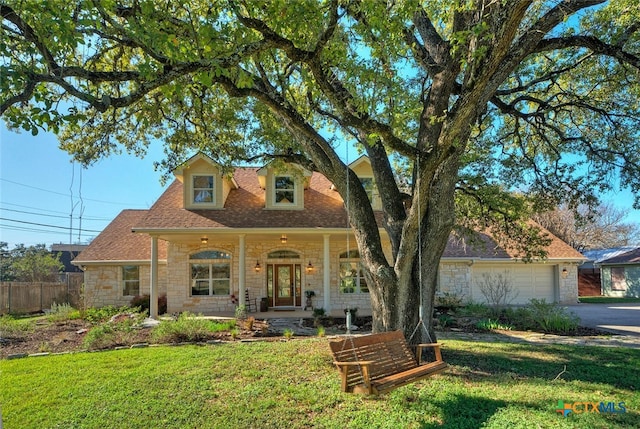 3701 Del Robles Dr, Austin, TX 78727 - view of front of house featuring fence, covered porch, a front yard, stone siding, and driveway