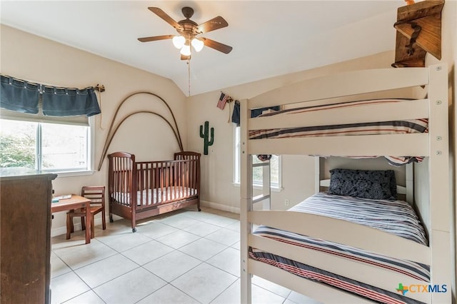 3701 Del Robles Dr, Austin, TX 78727 - bedroom featuring a ceiling fan, lofted ceiling, light tile patterned flooring, and multiple windows