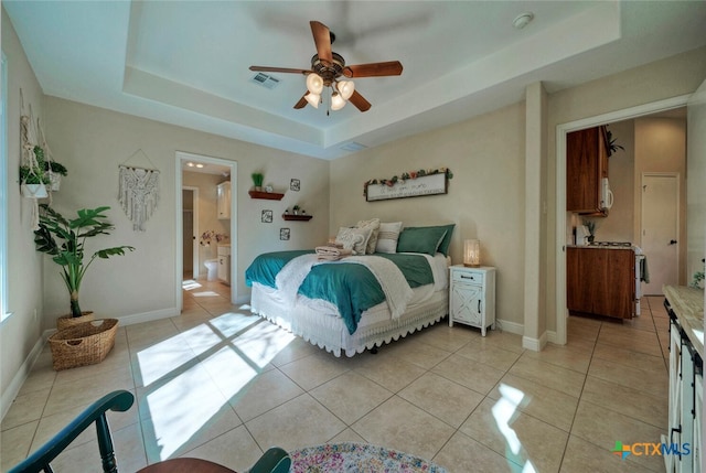 3701 Del Robles Dr, Austin, TX 78727 - bedroom with visible vents, a raised ceiling, ensuite bathroom, and light tile patterned floors
