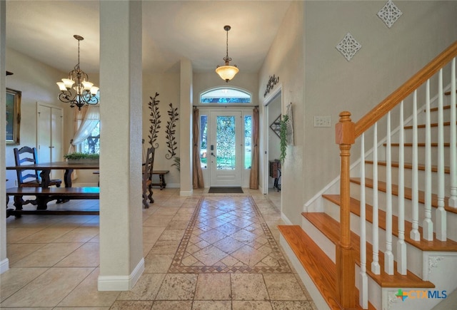 3701 Del Robles Dr, Austin, TX 78727 - entryway with a healthy amount of sunlight, baseboards, an inviting chandelier, and stairs