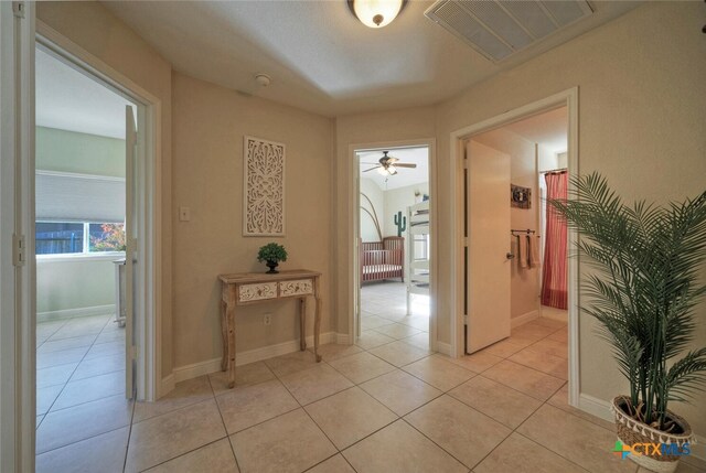 3701 Del Robles Dr, Austin, TX 78727 - hallway featuring light tile patterned flooring, baseboards, and visible vents