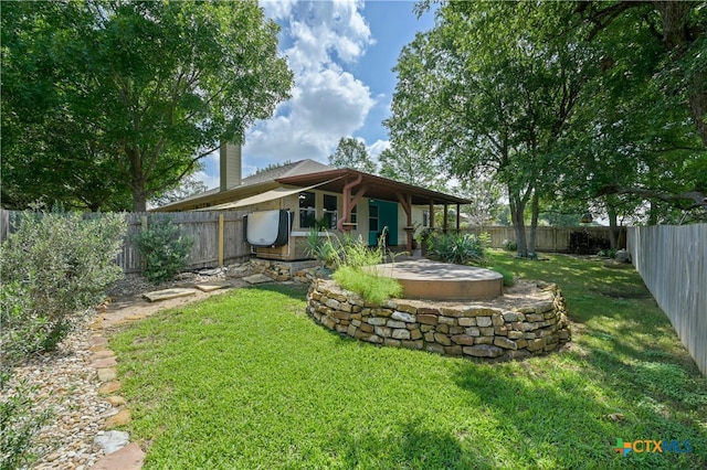 back of house with a lawn and a patio area