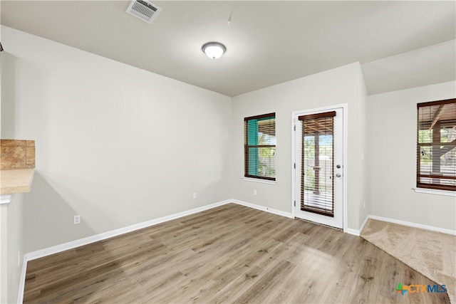 interior space with light wood-type flooring and a healthy amount of sunlight