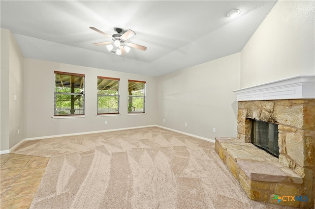 unfurnished living room featuring a fireplace, plenty of natural light, and light colored carpet