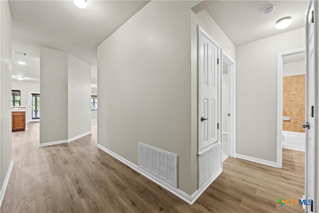 hall with light hardwood / wood-style flooring