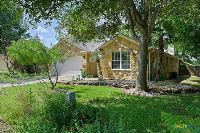 ranch-style house featuring a garage and a front yard