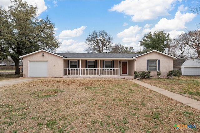 ranch-style home featuring a garage, concrete driveway, a porch, a front lawn, and brick siding